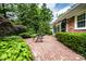 Brick patio surrounded by lush greenery, offering a charming outdoor retreat at 5415 Kilmer Ln, Indianapolis, IN 46250