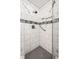 Shower with white tile, mosaic detail, and built-in niche at 5415 Kilmer Ln, Indianapolis, IN 46250