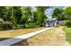 Nice backyard with long sidewalk leading to the small building at 5682 Broadway St, Indianapolis, IN 46220