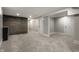 Finished basement featuring gray brick wall, carpet flooring and white doors at 5682 Broadway St, Indianapolis, IN 46220