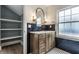 Stylish bathroom with wood vanity, granite countertop, black subway tile, and patterned tile floor at 5682 Broadway St, Indianapolis, IN 46220