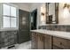 Bathroom featuring a vanity with a light countertop, gray tiling and unique sconces at 5682 Broadway St, Indianapolis, IN 46220