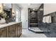 Beautiful bathroom features a stylish shower with built-in bench and a vanity with ample countertop space at 5682 Broadway St, Indianapolis, IN 46220