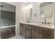 Bathroom featuring double vanity with modern fixtures and patterned tile flooring at 5682 Broadway St, Indianapolis, IN 46220