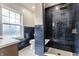 Modern bathroom features black subway tile shower with gold fixtures and patterned tile floor at 5682 Broadway St, Indianapolis, IN 46220