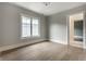 Neutral bedroom with light-colored wood floors, white trim, and a bright window at 5682 Broadway St, Indianapolis, IN 46220
