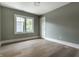Bedroom with hardwood floors, a bright window, and neutral colored walls at 5682 Broadway St, Indianapolis, IN 46220