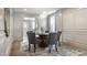Formal dining room with modern chandelier, wood floors, and paneled walls at 5682 Broadway St, Indianapolis, IN 46220