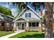 Charming two-story home with a well-manicured lawn and inviting front porch at 5682 Broadway St, Indianapolis, IN 46220