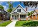 Charming two-story home with a well-manicured lawn and inviting front porch at 5682 Broadway St, Indianapolis, IN 46220