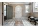 Elegant foyer with patterned tile flooring, arched doorways, and stylish bench at 5682 Broadway St, Indianapolis, IN 46220