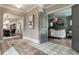 Elegant foyer with patterned tile flooring, arched doorways, and views of living spaces at 5682 Broadway St, Indianapolis, IN 46220