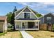 Charming two-story home with inviting front porch and manicured lawn at 5682 Broadway St, Indianapolis, IN 46220