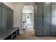 Inviting home entry showcasing gray hallway bench, coat rack, and archway to the living room at 5682 Broadway St, Indianapolis, IN 46220
