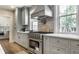 Well-equipped kitchen featuring stainless steel range, custom cabinetry, and stylish tile backsplash at 5682 Broadway St, Indianapolis, IN 46220