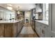 Modern kitchen with stainless steel appliances, an island with bar seating, and seamless flow to living area at 5682 Broadway St, Indianapolis, IN 46220