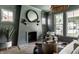 Living room featuring fireplace, hardwood floors, chair and natural light at 5682 Broadway St, Indianapolis, IN 46220