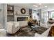 Cozy living room featuring a fireplace, built-in shelves, and stylish decor at 5682 Broadway St, Indianapolis, IN 46220