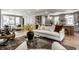 Beautiful living room with stylish furniture, a decorative rug, and an open connection to the modern kitchen at 5682 Broadway St, Indianapolis, IN 46220