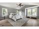 Spacious main bedroom features a soaring vaulted ceiling, hardwood floors, a ceiling fan and bright windows at 5682 Broadway St, Indianapolis, IN 46220