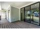 Relaxing covered outdoor patio with sliding glass doors and wooden floor at 5682 Broadway St, Indianapolis, IN 46220