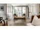 Bright sitting area with large windows and stylish seating, showcasing a tranquil view and elegant decor at 5682 Broadway St, Indianapolis, IN 46220