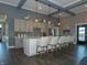 Stylish clubhouse kitchen with a counter bar, gray cabinetry, modern backsplash, and hardwood flooring at 6031 Madera Dr, Whitestown, IN 46075