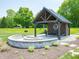 Community picnic area features covered structure with table and seating adjacent to a stone patio at 6031 Madera Dr, Whitestown, IN 46075