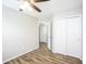 Bright bedroom features neutral walls, wood-look floors, ceiling fan, and closet for ample storage at 6121 Jester Ct, Indianapolis, IN 46254