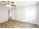 Bedroom boasts wood-look floors, neutral walls, a ceiling fan, and an open doorway at 6121 Jester Ct, Indianapolis, IN 46254