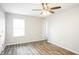 Bedroom features wood-look floors, natural light, and a ceiling fan at 6121 Jester Ct, Indianapolis, IN 46254
