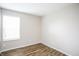 Bright, empty bedroom featuring neutral paint, wood-look flooring, and a large window at 6121 Jester Ct, Indianapolis, IN 46254