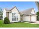 Well-maintained home showcasing brick accents, manicured landscaping and an attached two-car garage at 6121 Jester Ct, Indianapolis, IN 46254