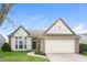 Charming home featuring a manicured lawn, brick accents, attached two-car garage and manicured landscaping at 6121 Jester Ct, Indianapolis, IN 46254