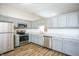 Well-lit kitchen featuring stainless steel appliances, gray cabinets and modern countertops at 6121 Jester Ct, Indianapolis, IN 46254