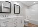 Modern bathroom with double vanity, framed mirrors, and shower-tub combination at 6528 Abby Ln, Zionsville, IN 46077