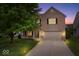Charming two-story brick house with a two-car garage and a well-manicured lawn at 6528 Abby Ln, Zionsville, IN 46077