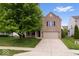 Charming brick two-story home featuring a two-car garage and a well-manicured front yard at 6528 Abby Ln, Zionsville, IN 46077