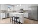 Modern kitchen with stainless steel appliances, white cabinets, and center island with seating at 6528 Abby Ln, Zionsville, IN 46077