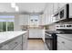 Well-lit kitchen with stainless steel appliances, white cabinets, and ample counter space at 6528 Abby Ln, Zionsville, IN 46077