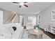 Comfortable living room featuring hardwood floors, neutral decor, and a staircase at 6528 Abby Ln, Zionsville, IN 46077