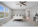Spacious main bedroom with large windows, a ceiling fan, and neutral decor at 6528 Abby Ln, Zionsville, IN 46077