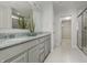 Bathroom with double vanity, granite countertop, stylish fixtures, and tiled walk-in shower at 6868 Jacone Dr, Brownsburg, IN 46112