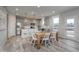 Open-concept kitchen and dining area with stainless steel appliances, grey cabinetry, and natural light at 6868 Jacone Dr, Brownsburg, IN 46112