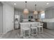 Stylish kitchen featuring a large island with seating, stainless steel appliances, and grey cabinets at 6868 Jacone Dr, Brownsburg, IN 46112