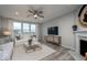 Cozy living room with a fireplace, large windows, and comfortable seating area, filled with natural light at 6868 Jacone Dr, Brownsburg, IN 46112