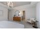 Bedroom featuring a round mirror, a wood dresser, accent chair, and modern lighting at 6868 Jacone Dr, Brownsburg, IN 46112