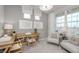 Bright office space with large windows, neutral colors, a desk, and sitting area with a chair at 6868 Jacone Dr, Brownsburg, IN 46112