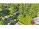 Aerial view of the home's landscaped yard, mature trees, and neighborhood street at 710 N Spring St, Greenfield, IN 46140