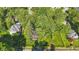 Aerial view of the home's landscaped yard, mature trees, and neighborhood street at 710 N Spring St, Greenfield, IN 46140